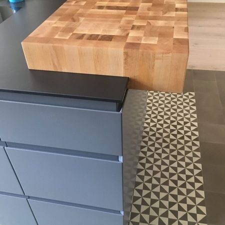 Ein Schneidebrett liegt auf einer Kücheninsel, bereit zum Zubereiten von Zutaten.