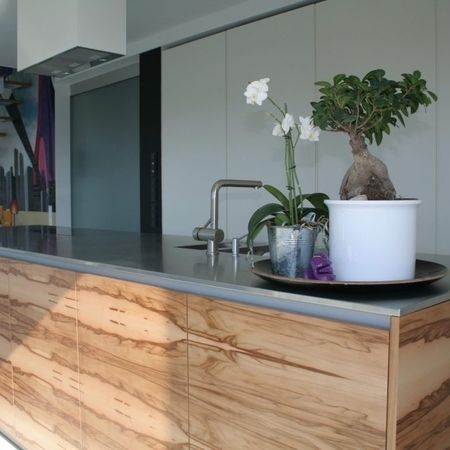 Eine Küche mit einer Holzinsel und einer Pflanze darauf.